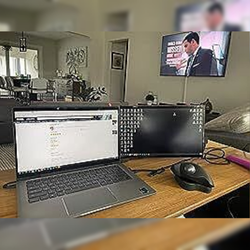 Cliente trabajando desde casa con laptop y monitor portátil Mobile Pixels, configuración de oficina en casa con pantalla extendida para mayor productividad y eficiencia en multitareas.